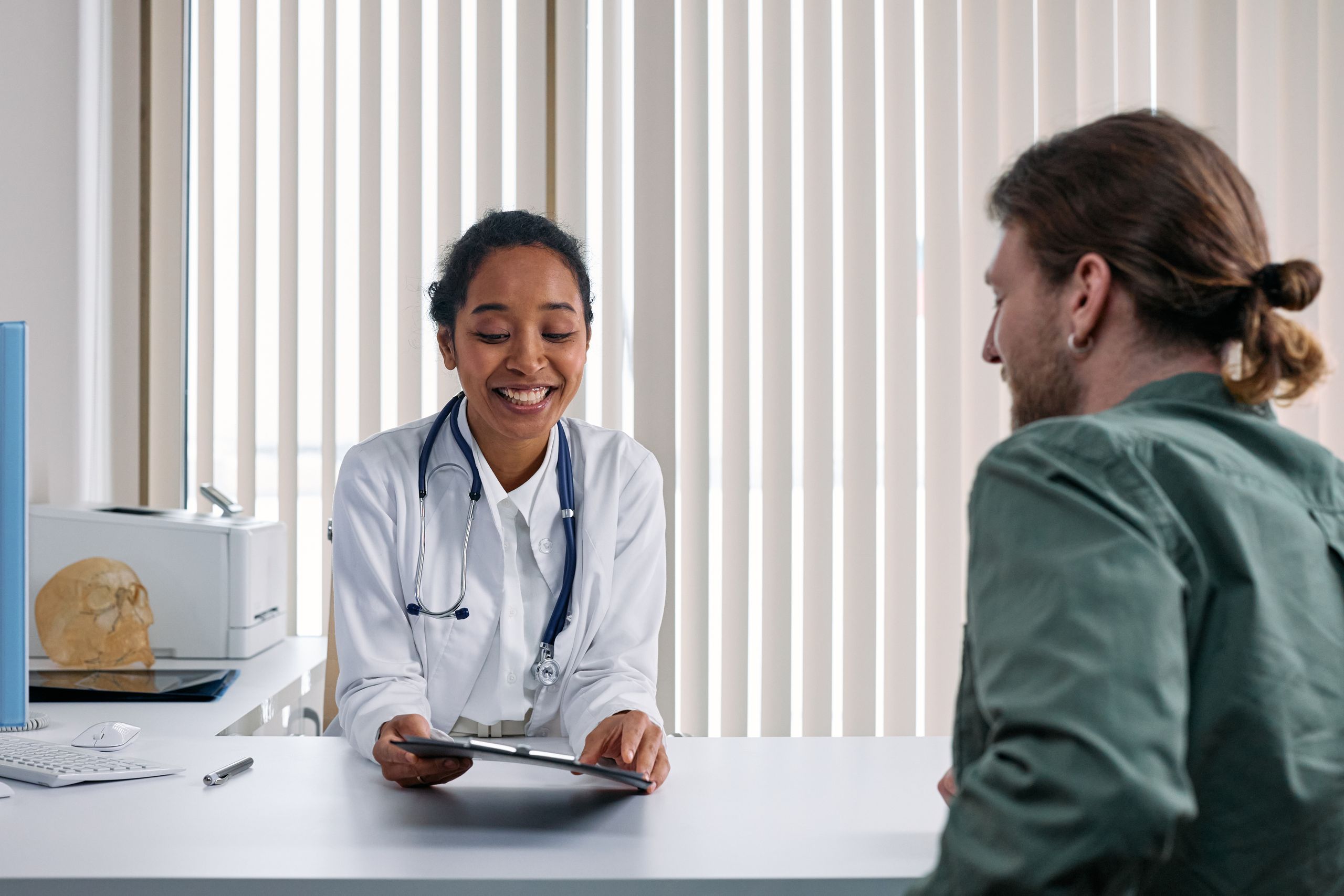 A StarMed doctor smiling and talking with a patient during a visit